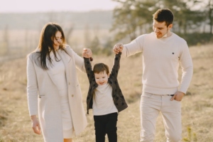 Parents playing with their child in nature.