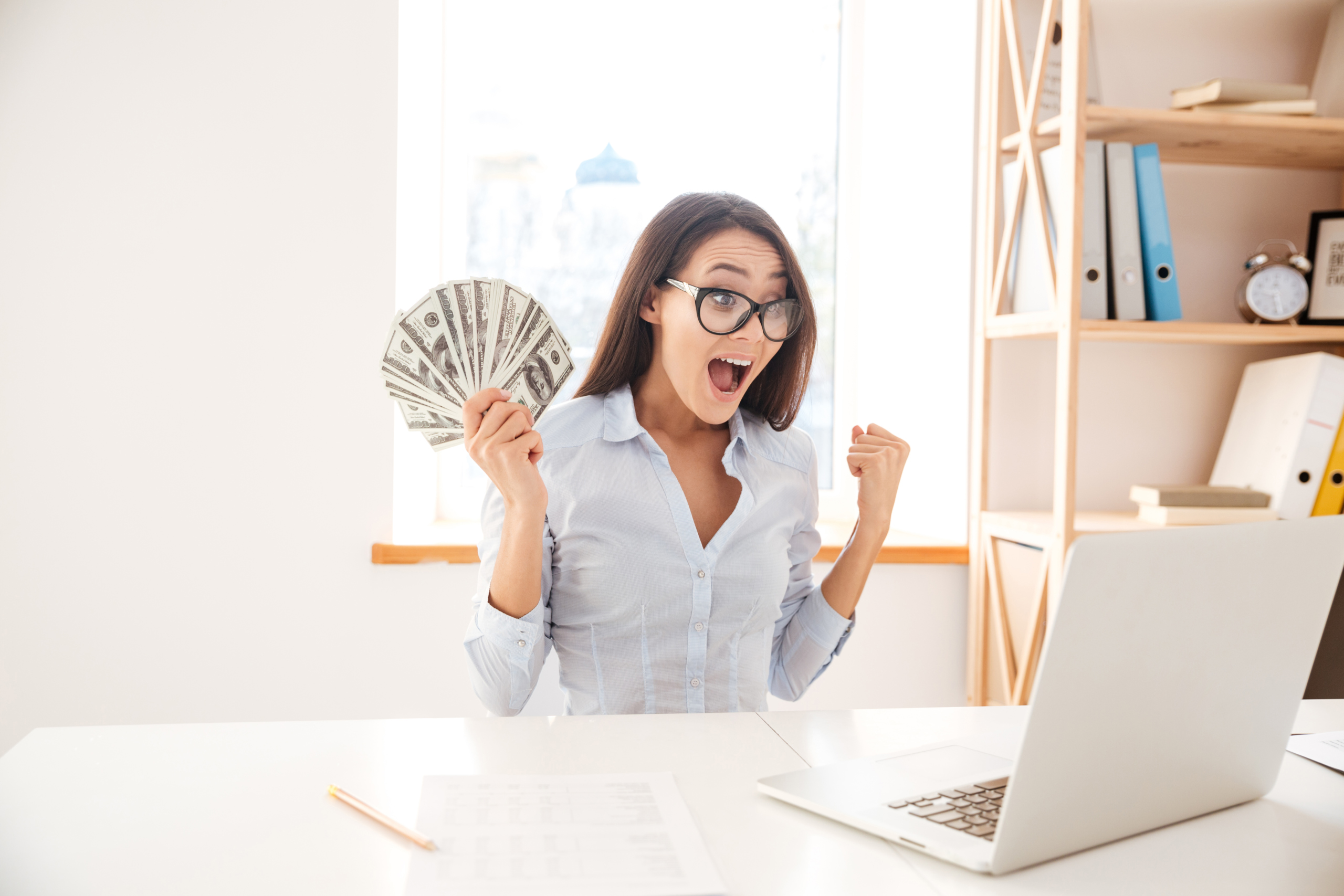 public/uploads/2021/10/graphicstock-image-of-businesswoman-dressed-in-white-shirt-sitting-in-her-office-and-holding-money-in-hand-while-making-winner-gesture_r8TFKKmd3g-scaled.jpg