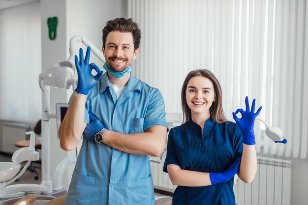 public/uploads/2021/11/photo-smiling-dentist-standing-with-arms-crossed-with-her-colleague-showing-okay-sign_496169-1043.jpg