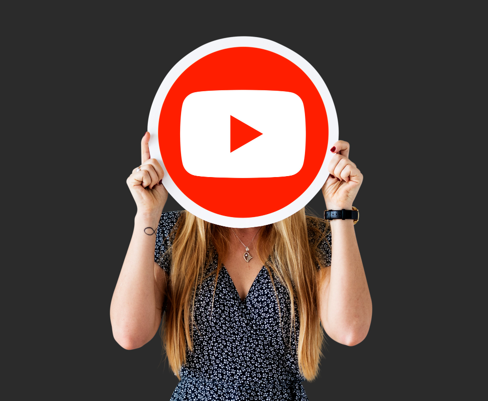 public/uploads/2023/10/woman-holding-youtube-icon.jpg